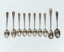 A collection of silver coffee spoons.