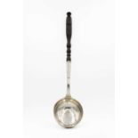 An 18th-century continental silver ladle with turned wood handle.