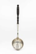 An 18th-century continental silver ladle with turned wood handle.