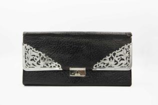 An Edwardian silver and leather glove wallet. by P W S.