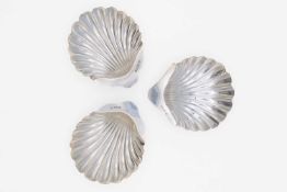 An Edwardian silver pair of scallop shell butter dishes by James Deakin & Sons, and one other.