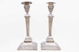 An Edwardian silver pair of Corinthian column table candlesticks by Hawksworth, Eyre & Co Ltd.