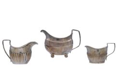 A George III silver milk jug, and two other silver milk jugs.