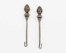 A pair of silver button hooks.