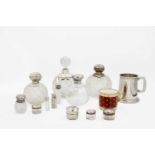 A collection of cut glass silver lidded scent bottles.