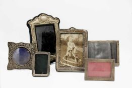 A collection of five silver photo frames.