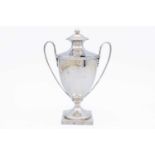A George III silver twin handled pedestal lidded mustard pot by Abraham Peterson & Peter Podio.