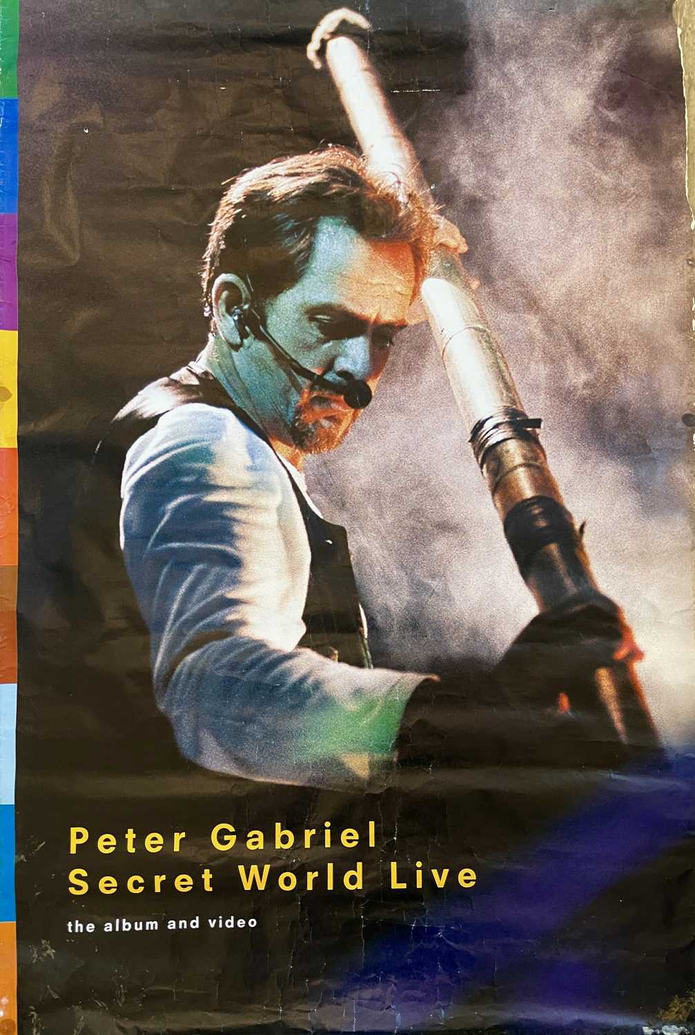 A 'Peter Gabriel: Secret World Live' poster.