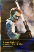 A 'Peter Gabriel: Secret World Live' poster.