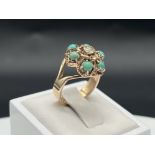 A 9ct yellow gold turquoise + diamond ring
