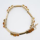 A 9ct yellow gold fancy deco design amber bracelet