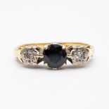 An 18ct yellow gold sapphire + diamond ring