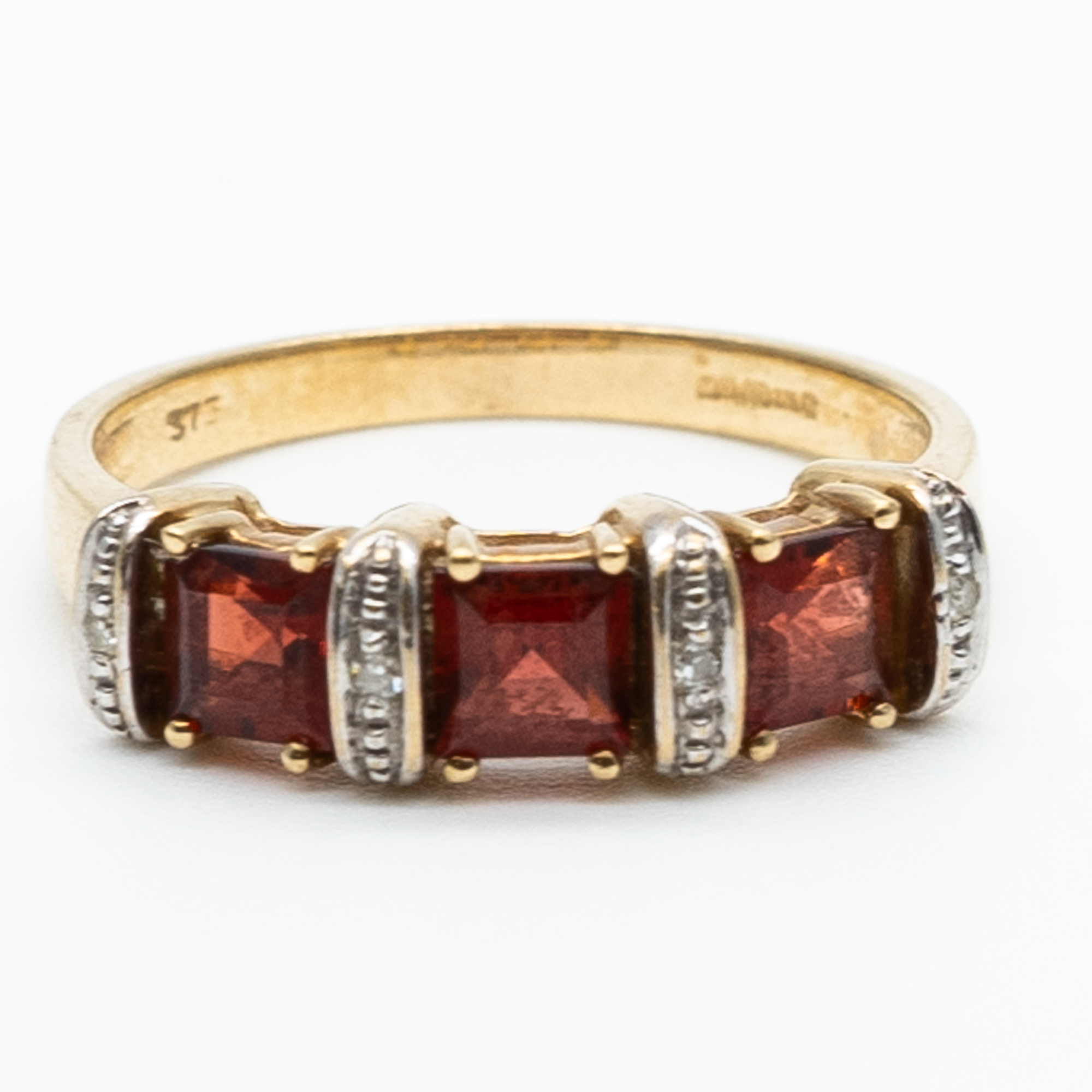 A 9ct yellow gold garnet and diamond dress ring