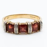 A 9ct yellow gold garnet and diamond dress ring