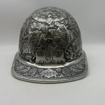 A vintage McDonald engraved high relief aluminium safety hat