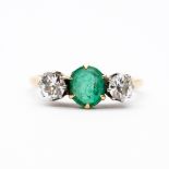 An 18ct yellow gold emerald and diamond ring