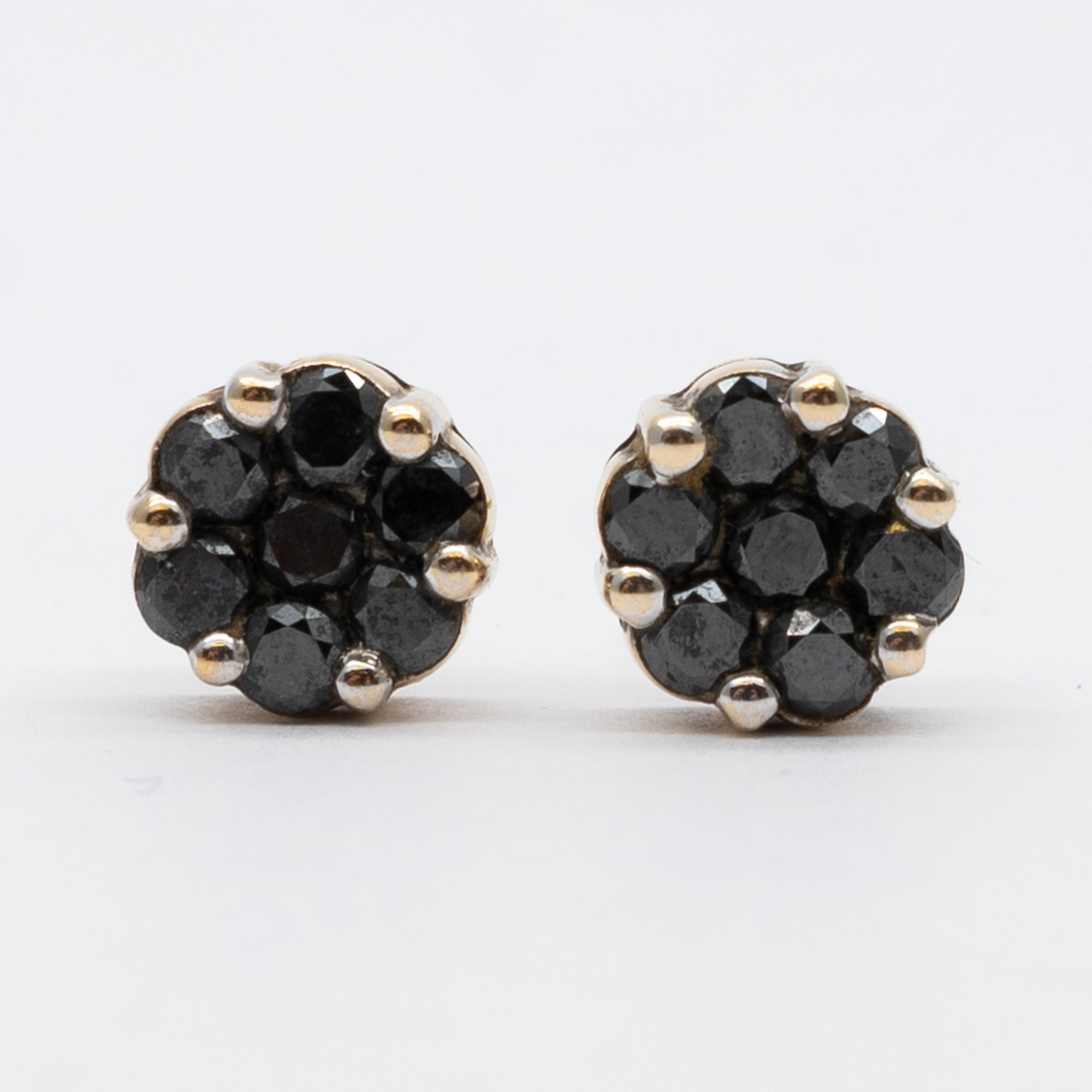 A pair of 9ct yellow gold black diamond stud earrings