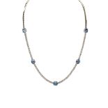 An 18ct white gold diamond and oval aquamarine necklace