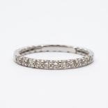 An 18ct white gold diamond set wedding band