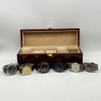 A brown lacquered watch box with 6 watches