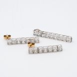 A pair of 9ct white gold cz princess cut drop earrings and matching pendant