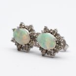 A pair of 18ct white gold opal and diamond earrings
