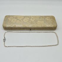 A silver clasp synthetic pearl necklace