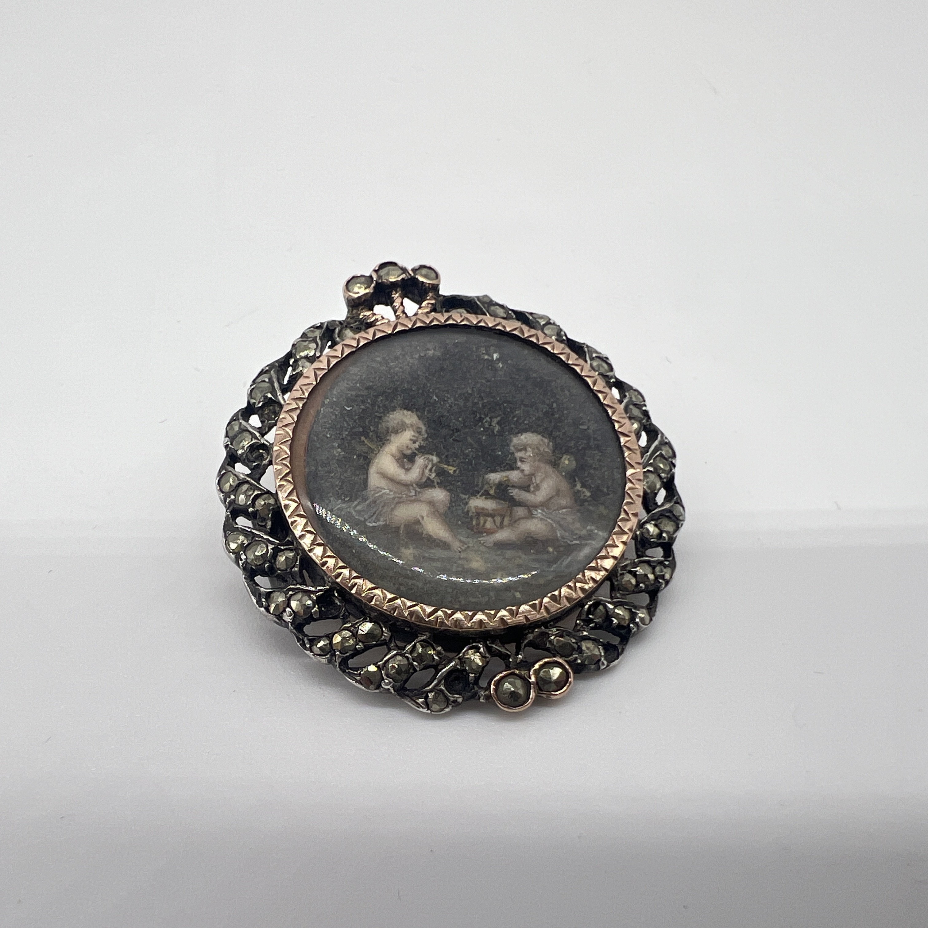 A Victorian marques stone set pictorial brooch