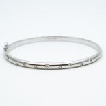 An 18ct white gold diamond set bangle