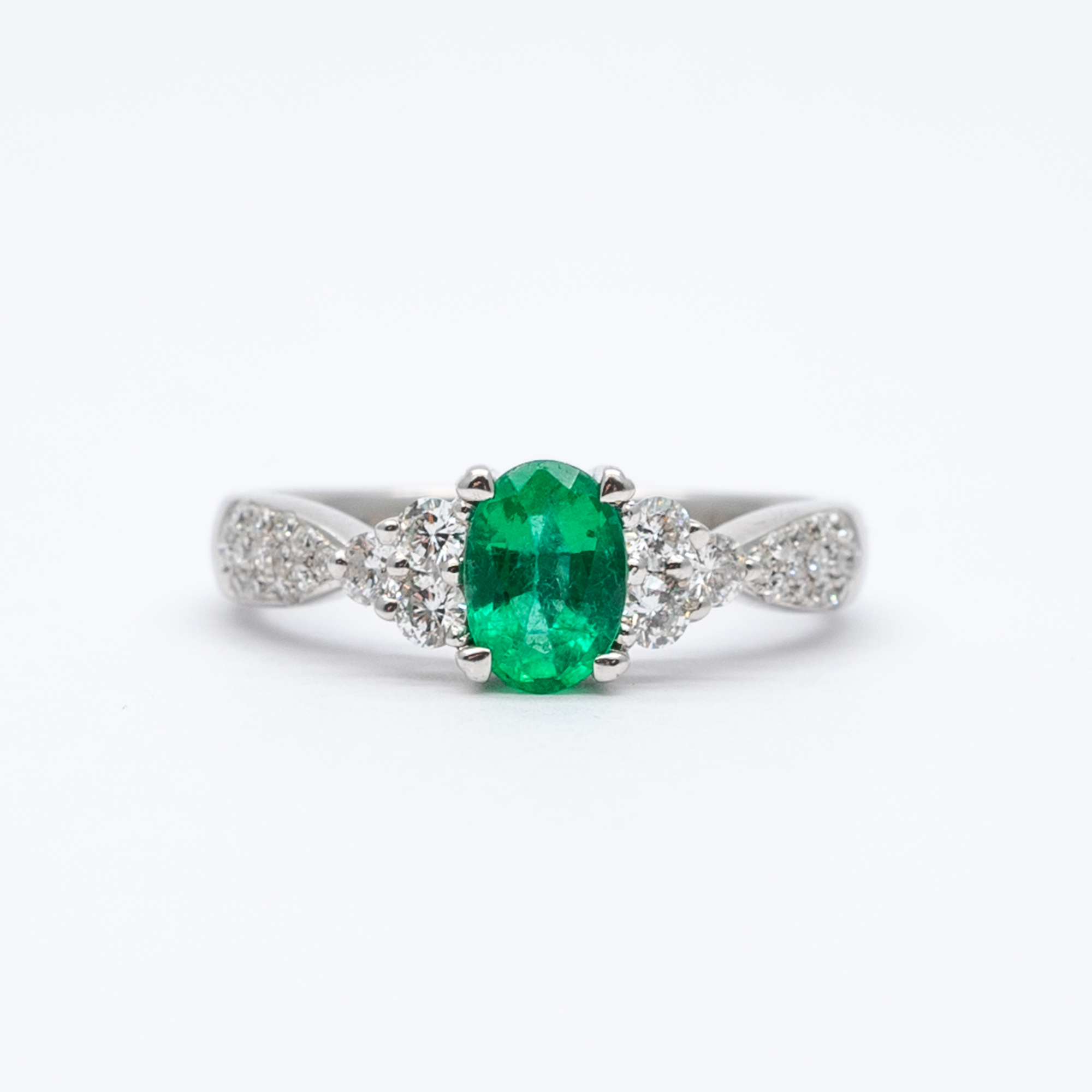 A 14ct white gold columbian emerald and diamond ring