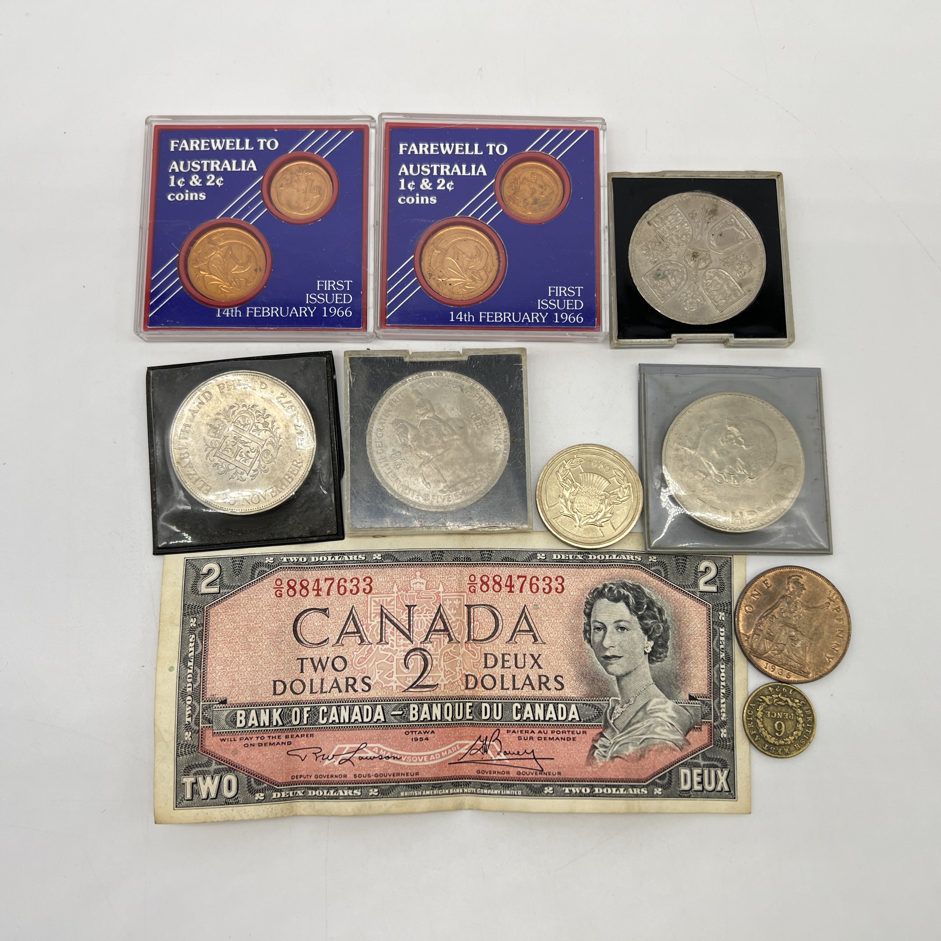 A collection of old coins and bank note