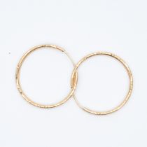 A pair of 9ct yellow gold diamond cut hoop earrings