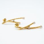 A pair of 18ct yellow gold drop diamond earrings