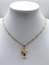 An 18ct yellow gold Egyptian jug pendant and chain