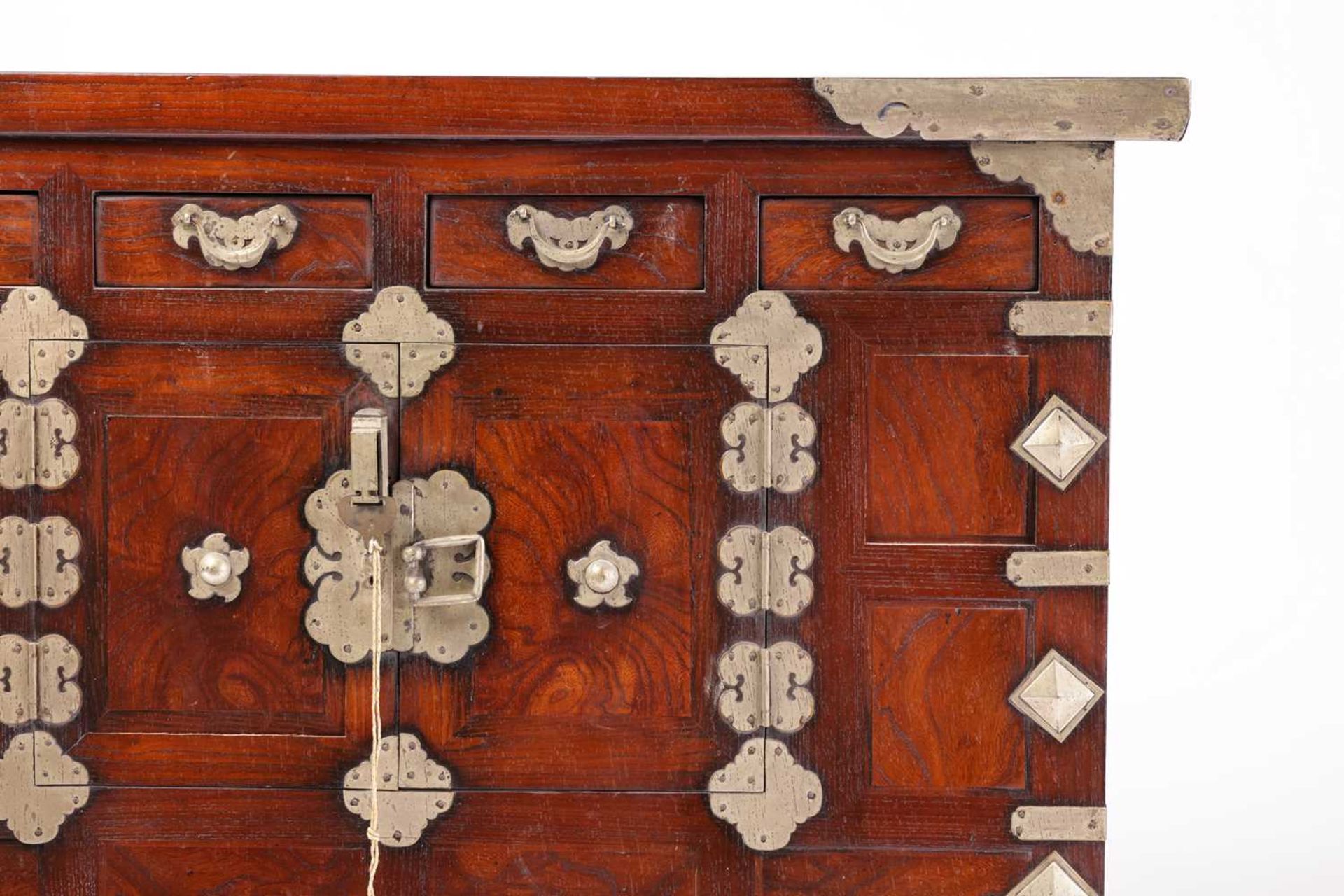 A Korean brass banded elm and stained pine Morijang cabinet with four short drawers over a pair of - Image 4 of 5