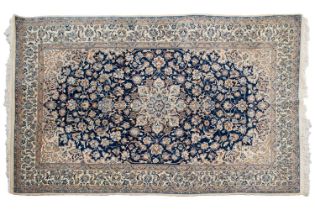 A navy blue ground Nain rug with central polylobate medalion and hanging lanterns within palmette