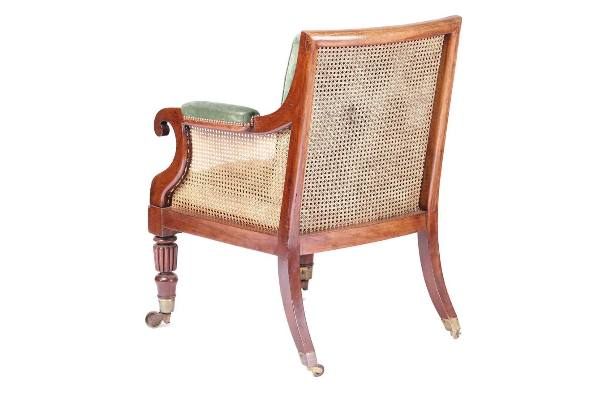 A George IV mahogany frame bergere library chair in the manner of Holland & Co, with cane back and - Image 6 of 7