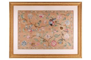 A Queen Anne embroidered silk panel depicting a tree with various flowers and exotic birds with a