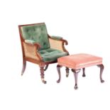 A George IV mahogany frame bergere library chair in the manner of Holland & Co, with cane back and