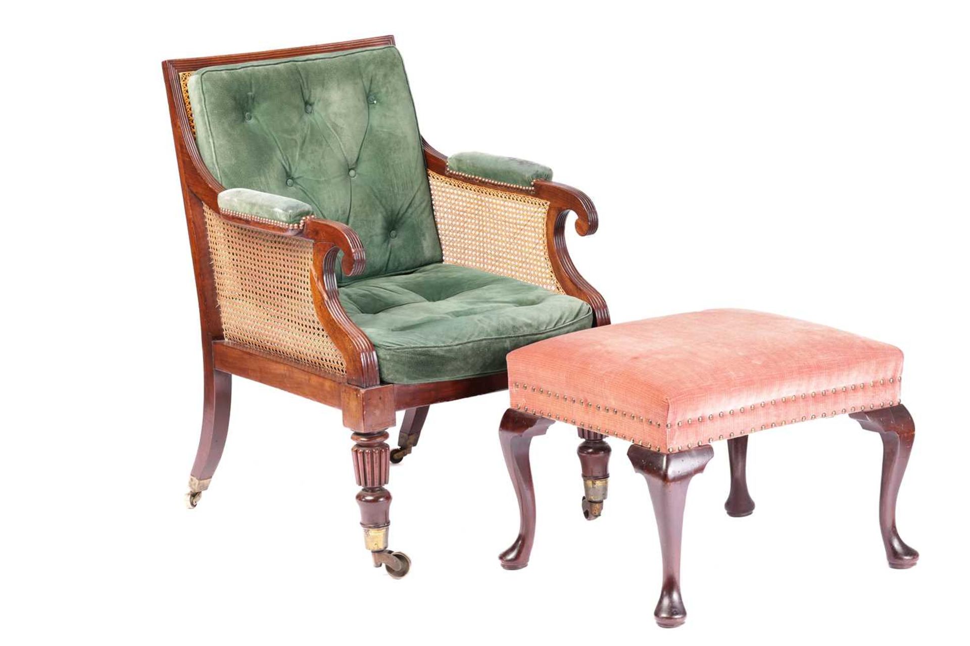 A George IV mahogany frame bergere library chair in the manner of Holland & Co, with cane back and