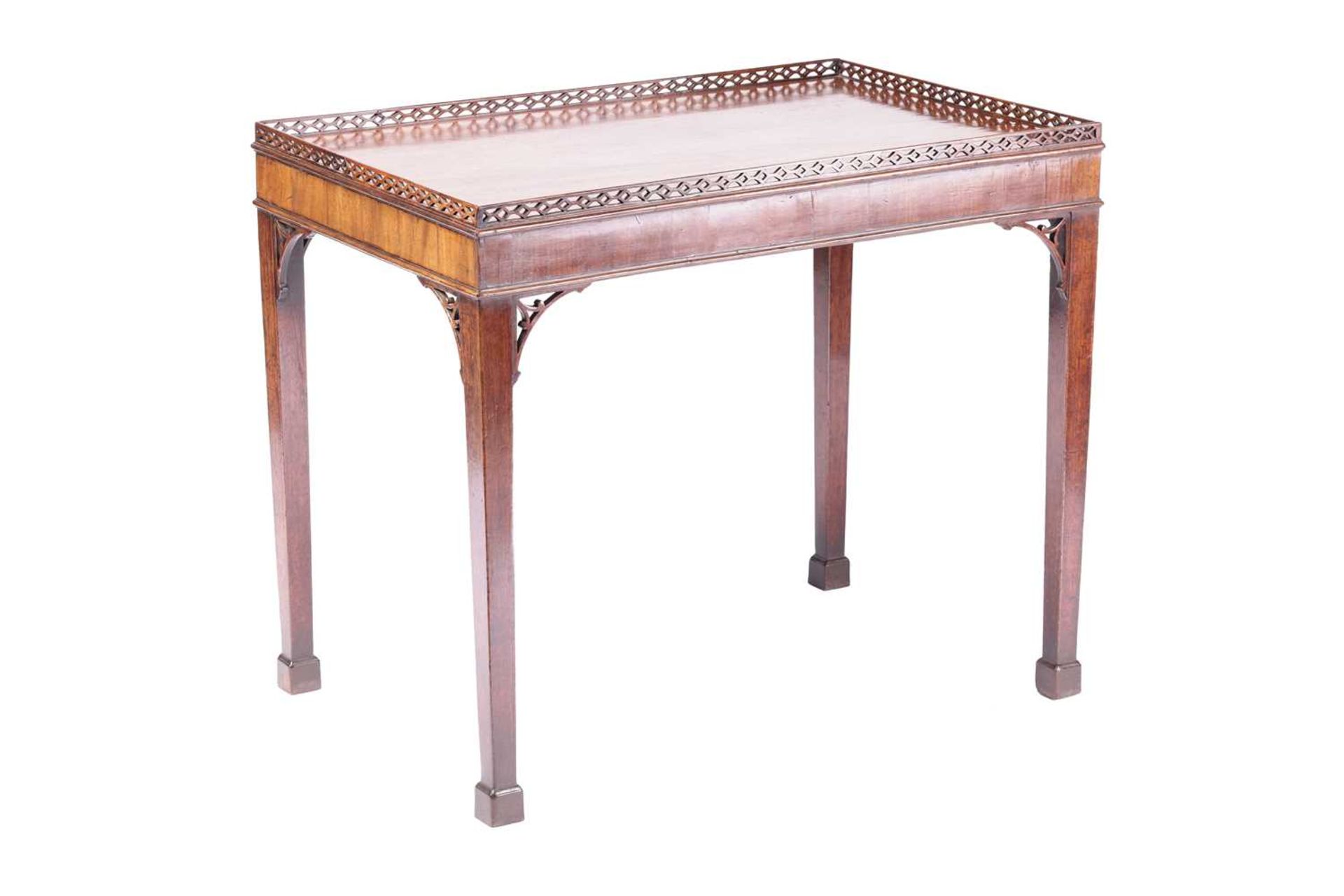 A George III mahogany rectangular silver table with a pierced gallery top and corner brackets, on