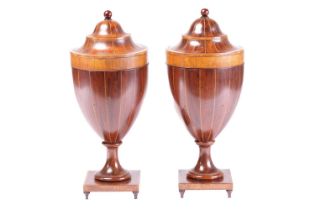 A fine pair of George III Sheraton period mahogany cutlery urn and covers, with fitted galleries