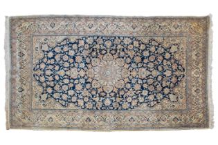 A navy blue ground Nain carpet with lobed central boss with hanging lanterns, within broad palette