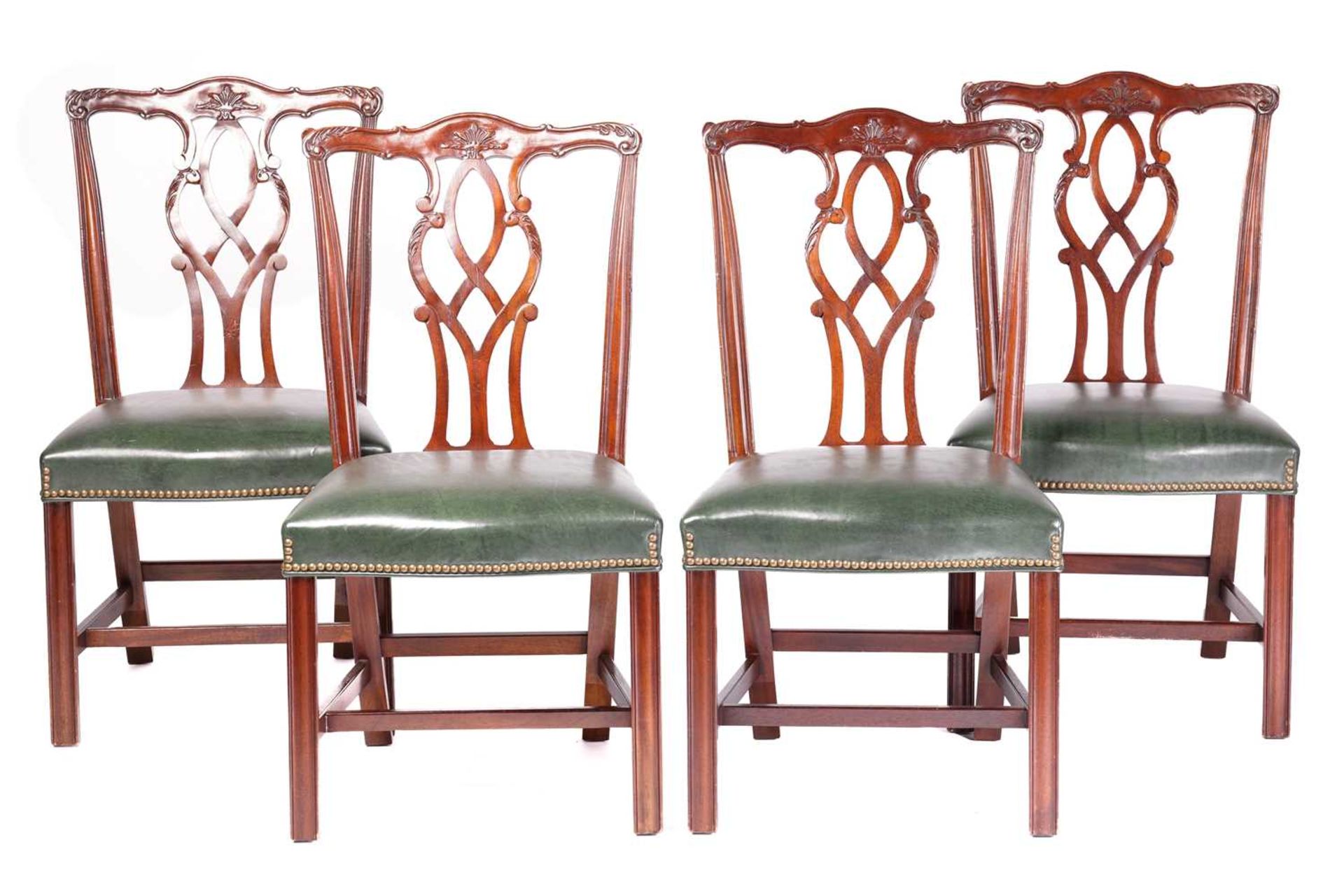 Four George III-style mahogany dining chairs, twentieth century above stuff over close nailed hide