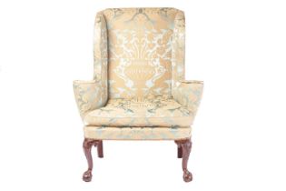 A George II 18th-century scroll arm wing back armchair with close nailed stuff over silk Damask