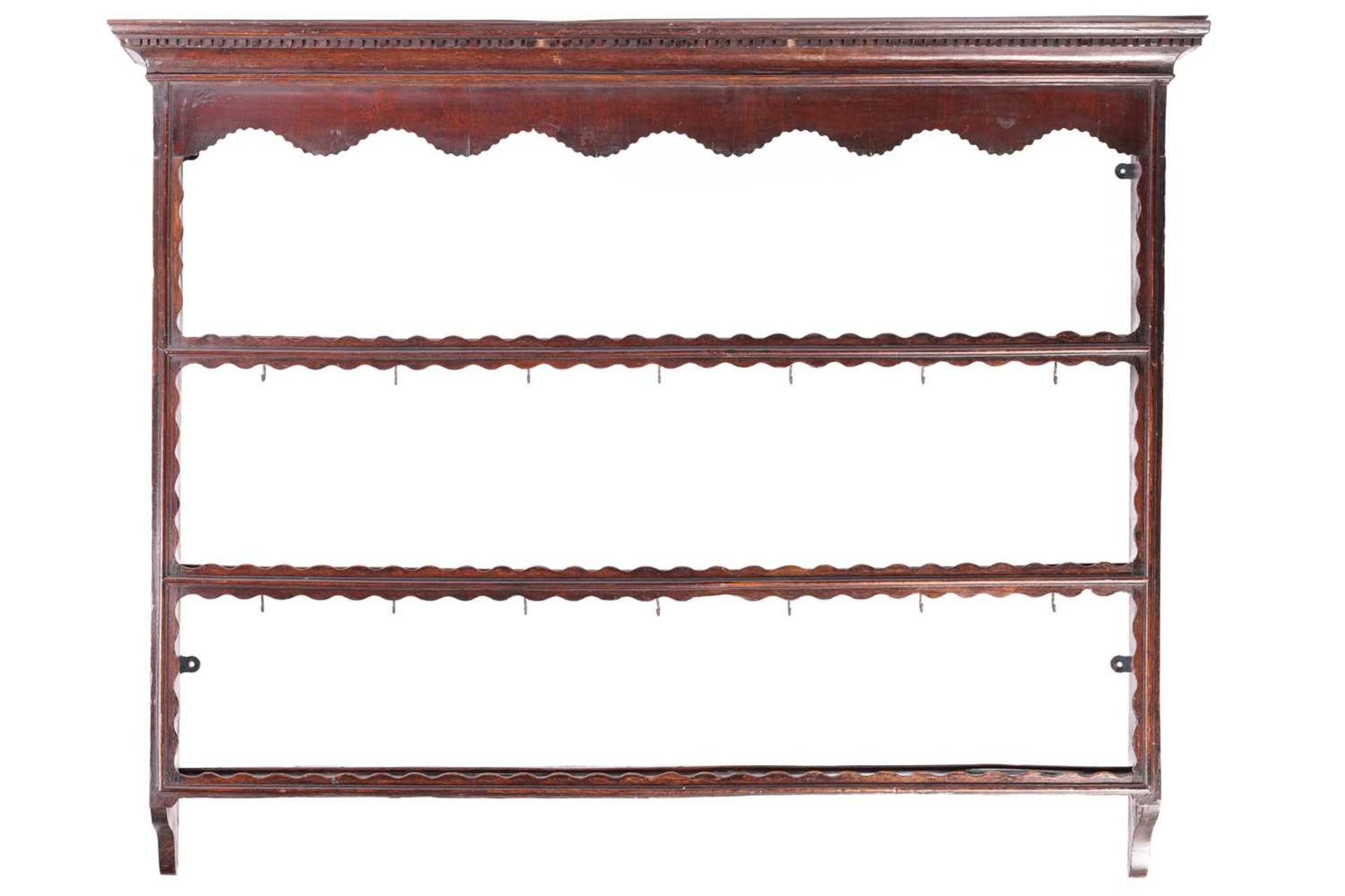 An 18th-century oak three-tier Delft rack with dental cornice, 104 cm high, 132 cm wide, 15.5 cm