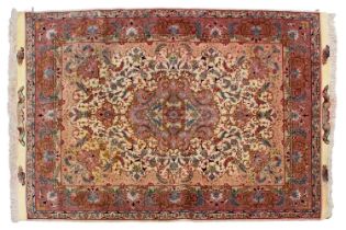 An ivory ground Tabriz rug with a "Bookcover" design with silk highlight detail bearing an