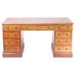 A Victorian mahogany twin pedestal kneehole desk with tooled leather inset and crossbanded border,