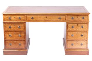 A Victorian mahogany twin pedestal kneehole desk with tooled leather inset and crossbanded border,