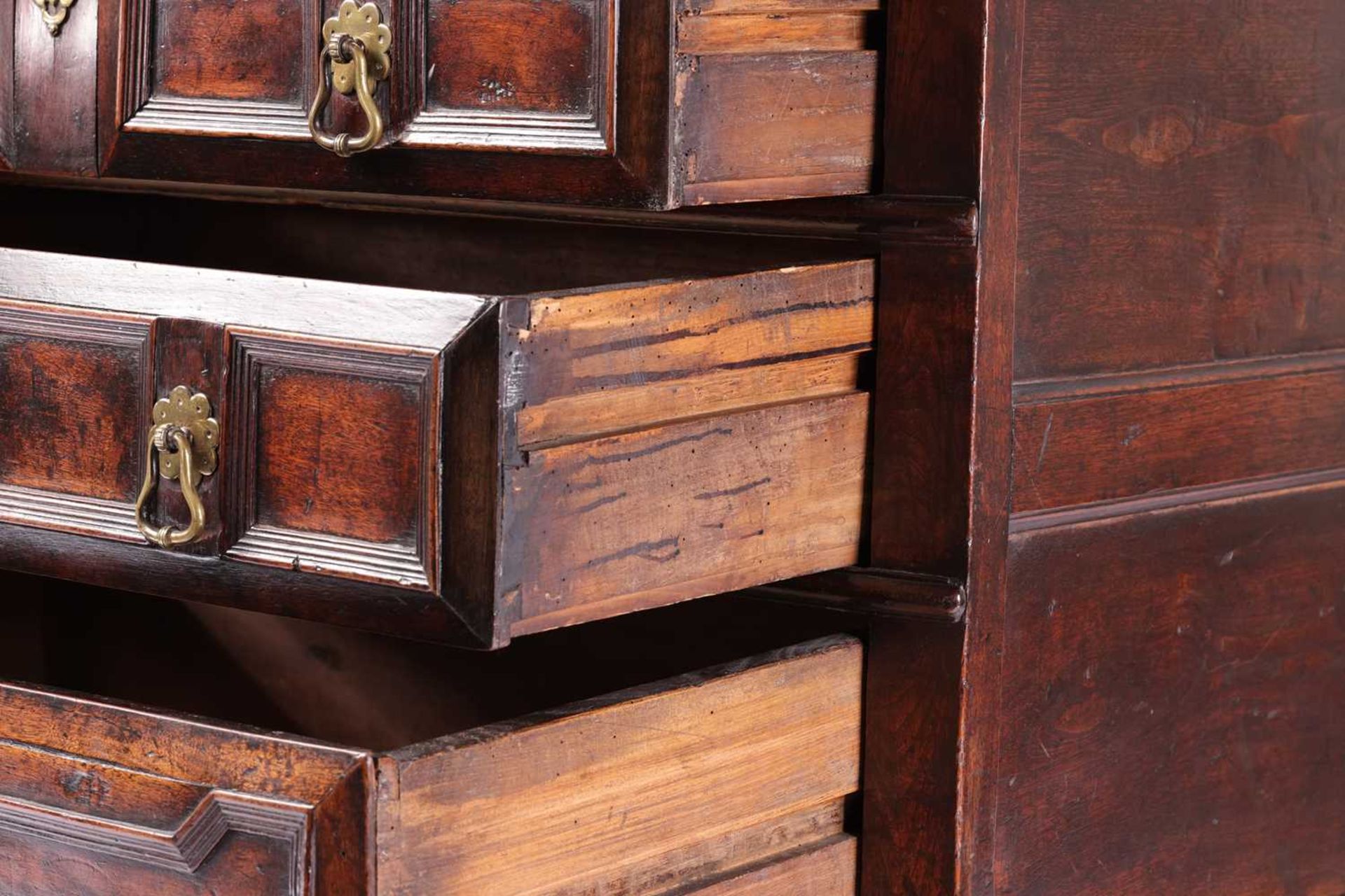 A late 17th-century walnut chest of four long drawers with raised geometric moulded fronts and - Image 4 of 10